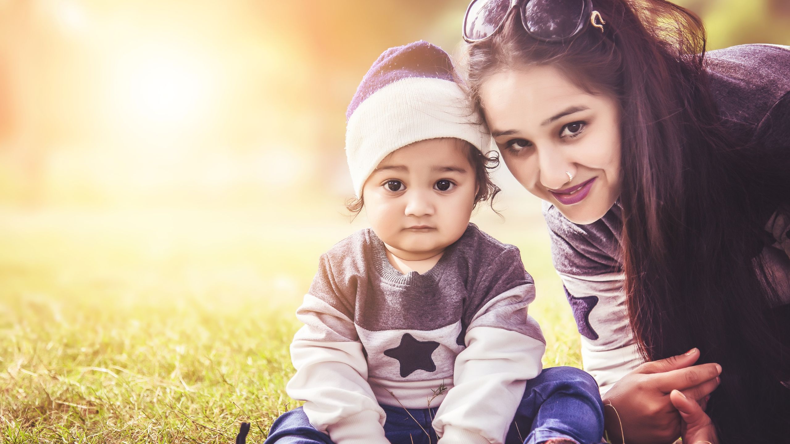 mother and daughter on green grass