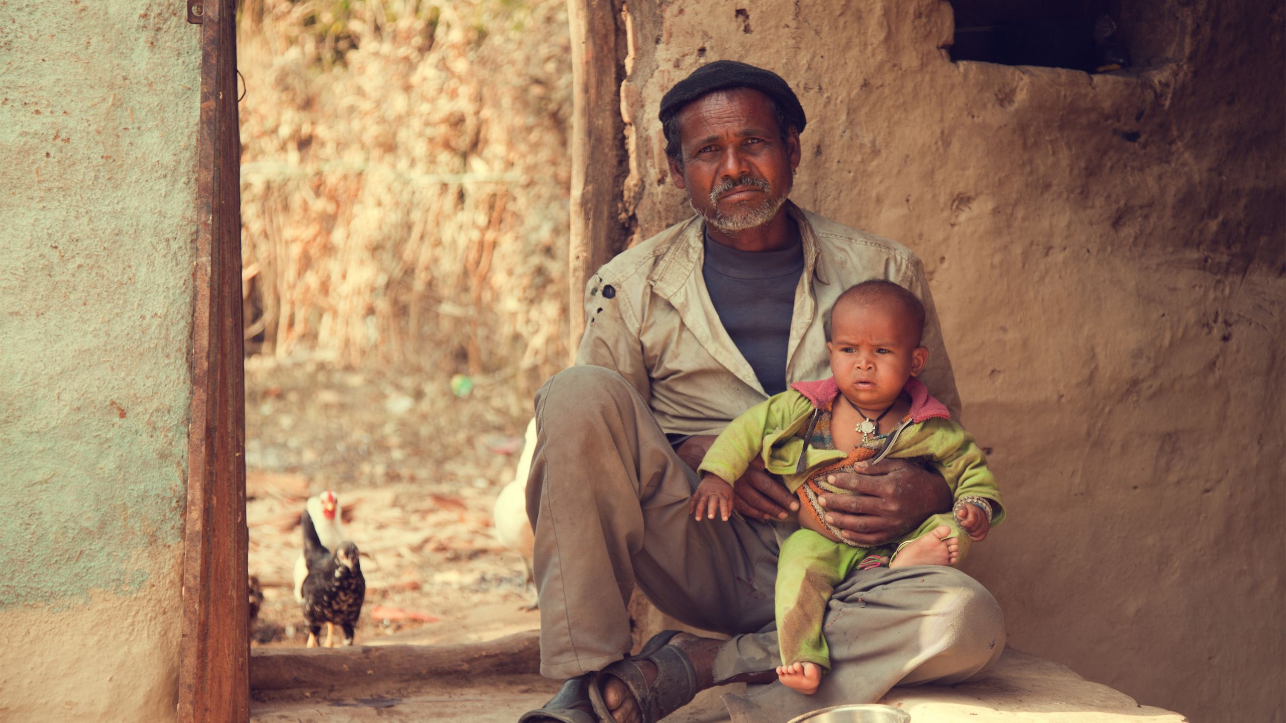 Father and son sitting on the ground