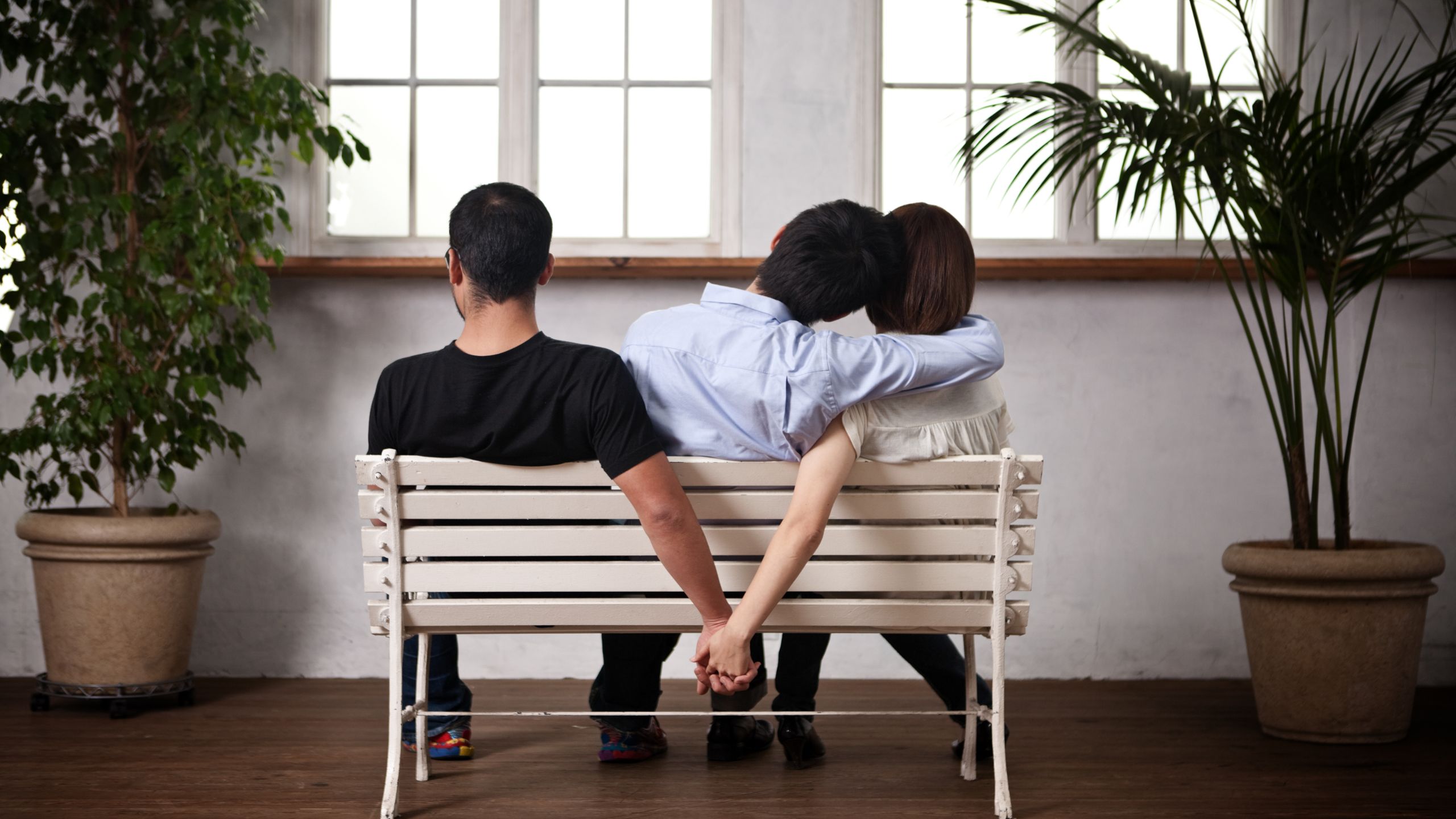 Three friends sitting on a chair