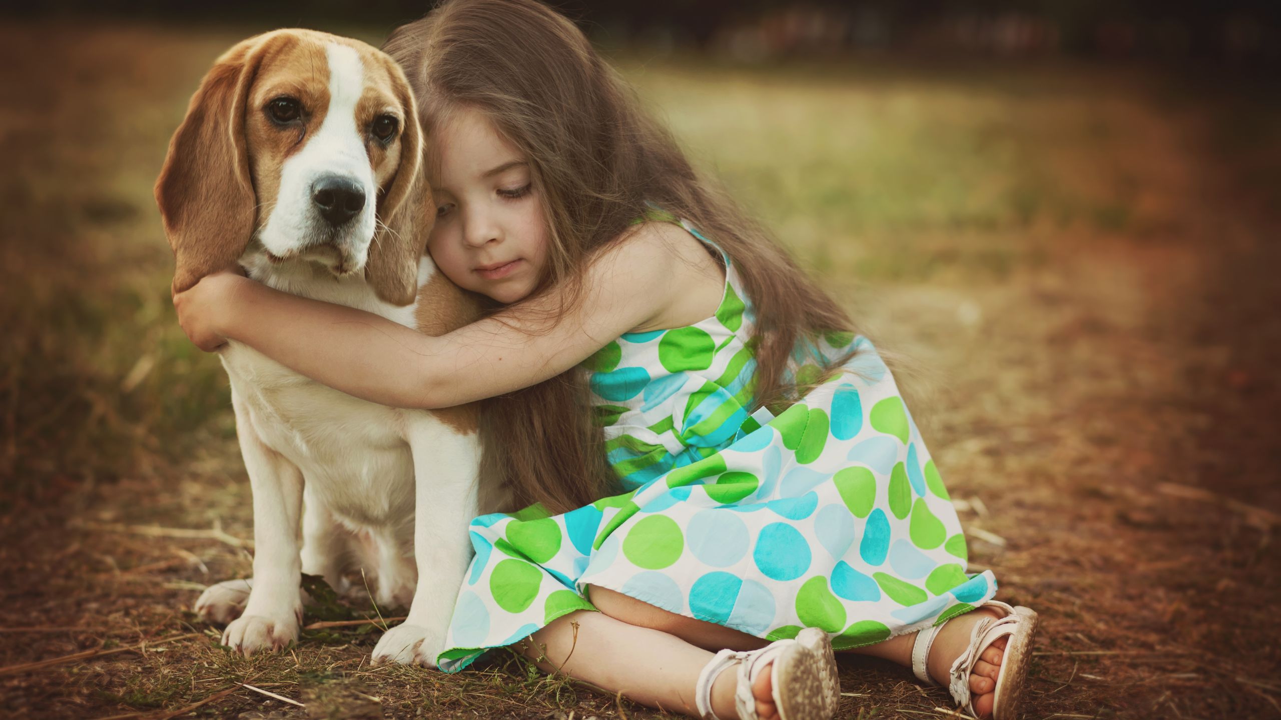A little girl hugging a dog as her true friend